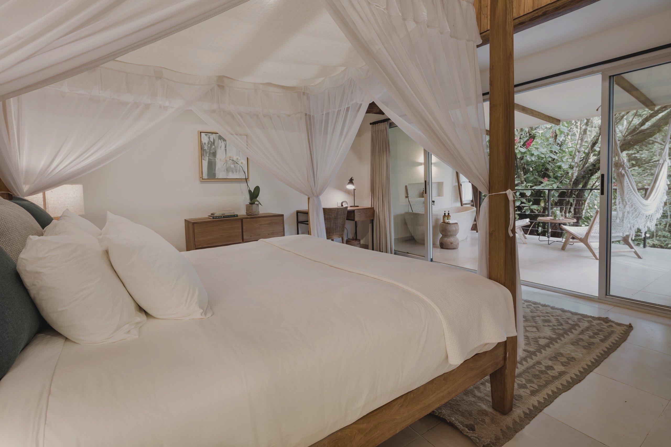 A boutique bungalow suite with a canopy bed at the barefoot-luxury sanctuary